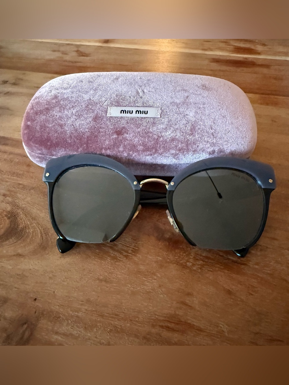 Miu Miu Black Round-Edge Sunglasses with Gold Accents